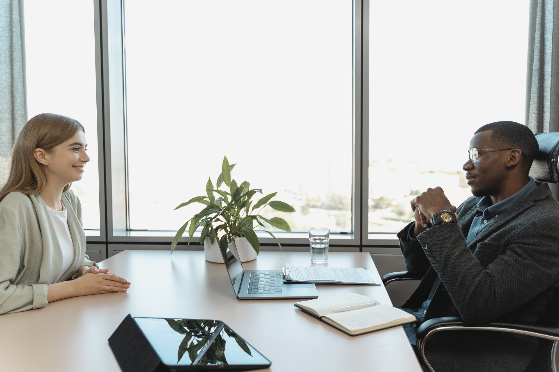 man-woman-at-desk Man and woman discussing exit interviews