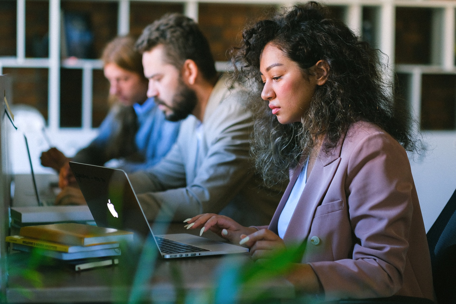 Diverse group of three professionals researching employee attrition