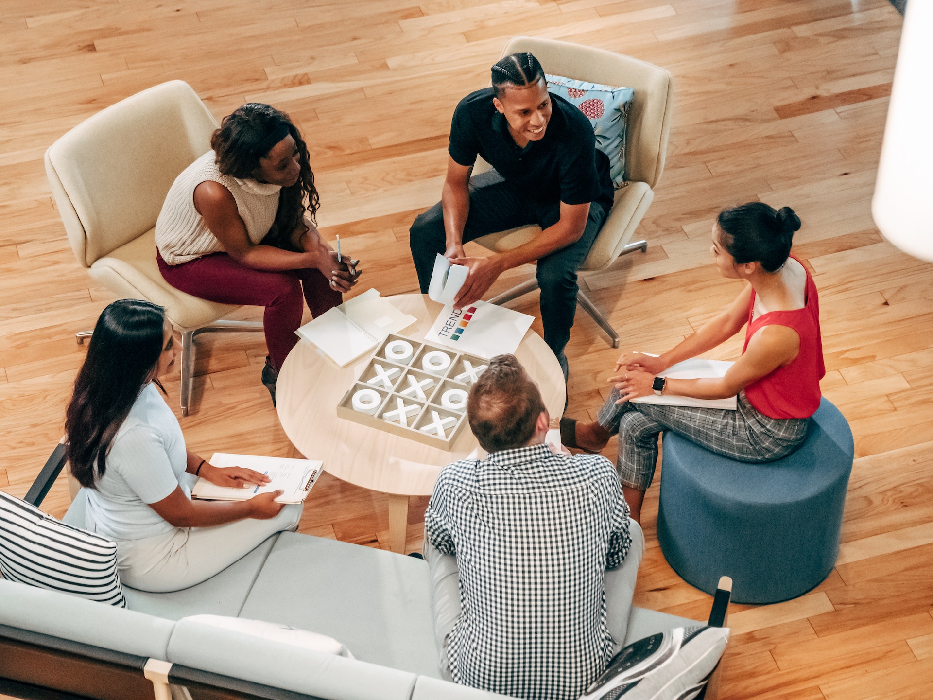 Overhead view of diverse group of colleagues discussing management values
