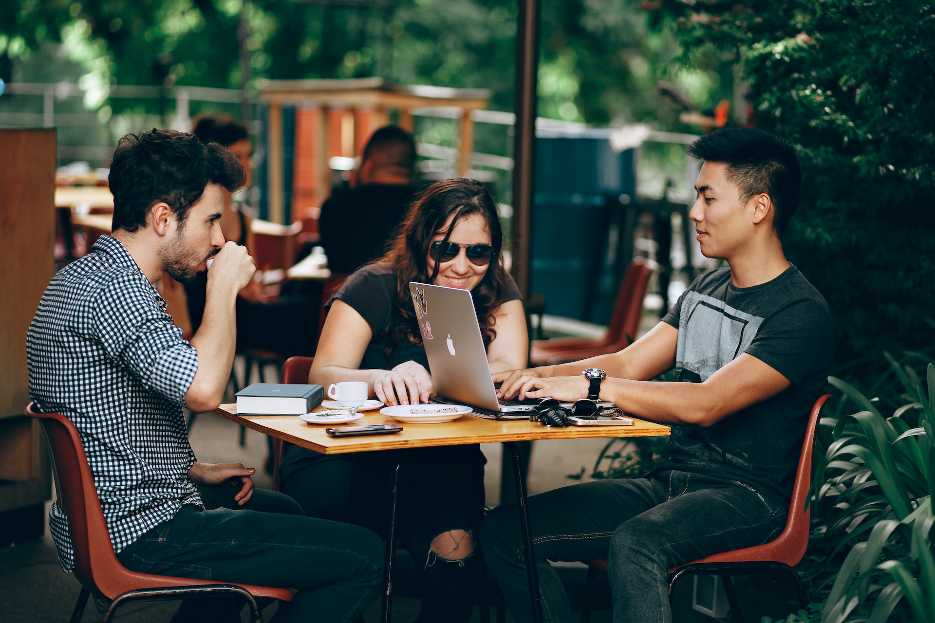 men-woman-outside-desk Three colleagues in casual dress outside working on goal setting activities