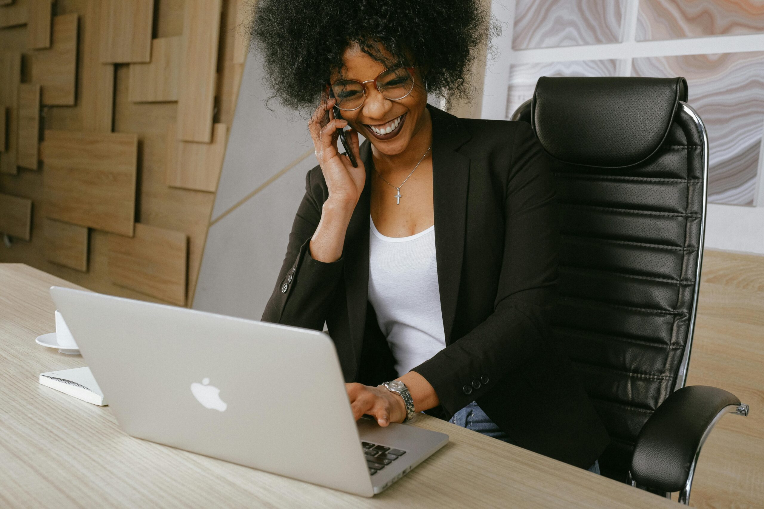 woman-in-black-blazer-sitting-on-black-office-chair A manager with a very open and honest leadership style