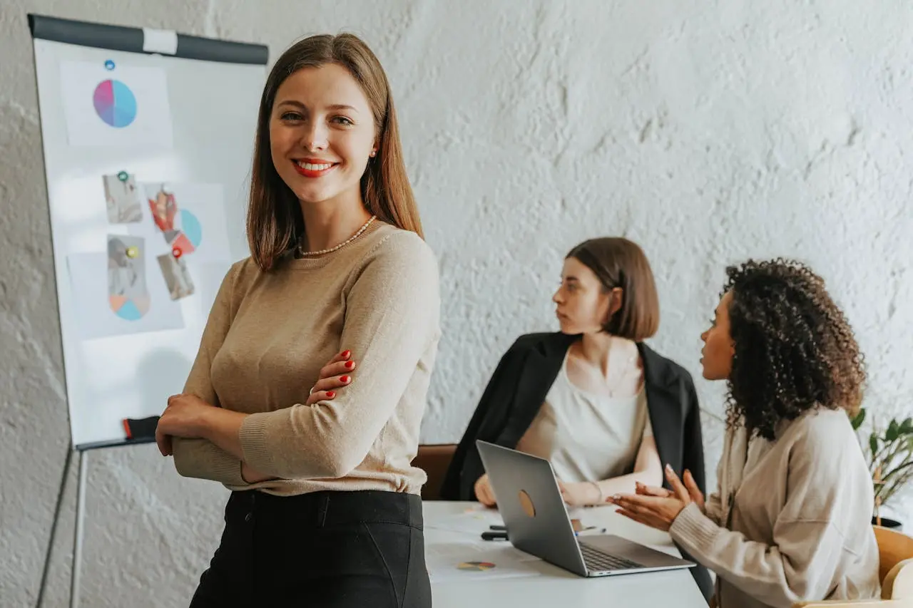 a-woman-in-brown-long-sleeve-standing-beside-a-desk