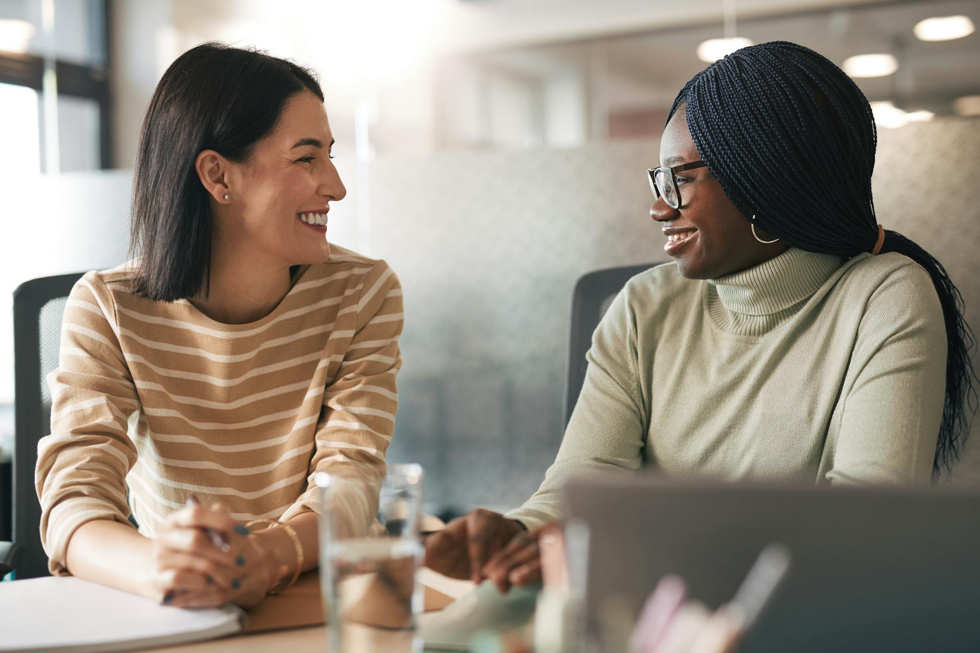 female-colleagues-sharing-feedback two female colleagues sharing feedback