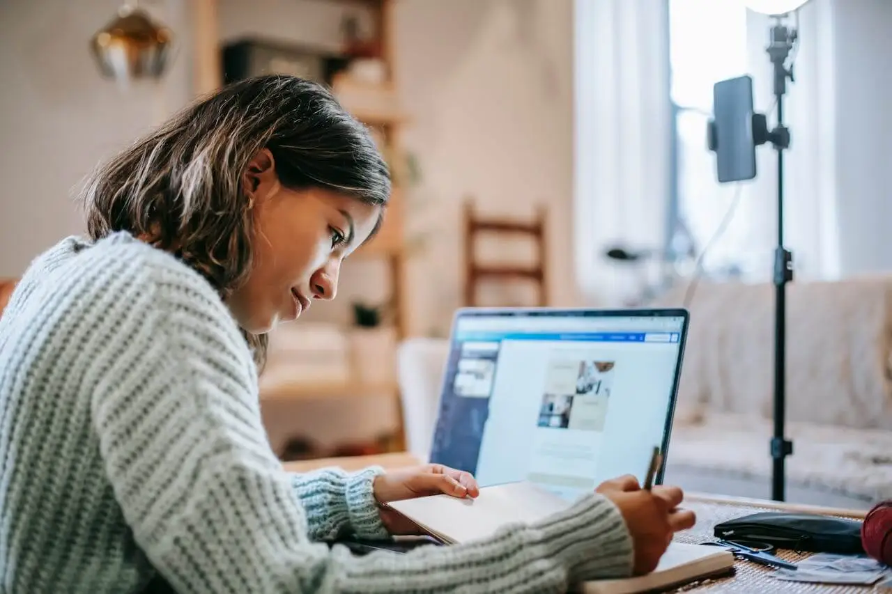 Hispanic-woman-on-laptop-working employee enjoying perks of having autonomy at work