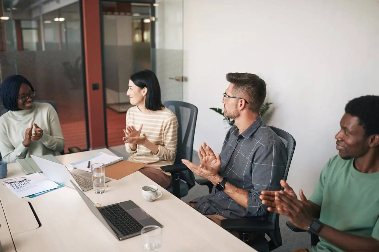 four-colleagues-sitting-clapping-after-presentation